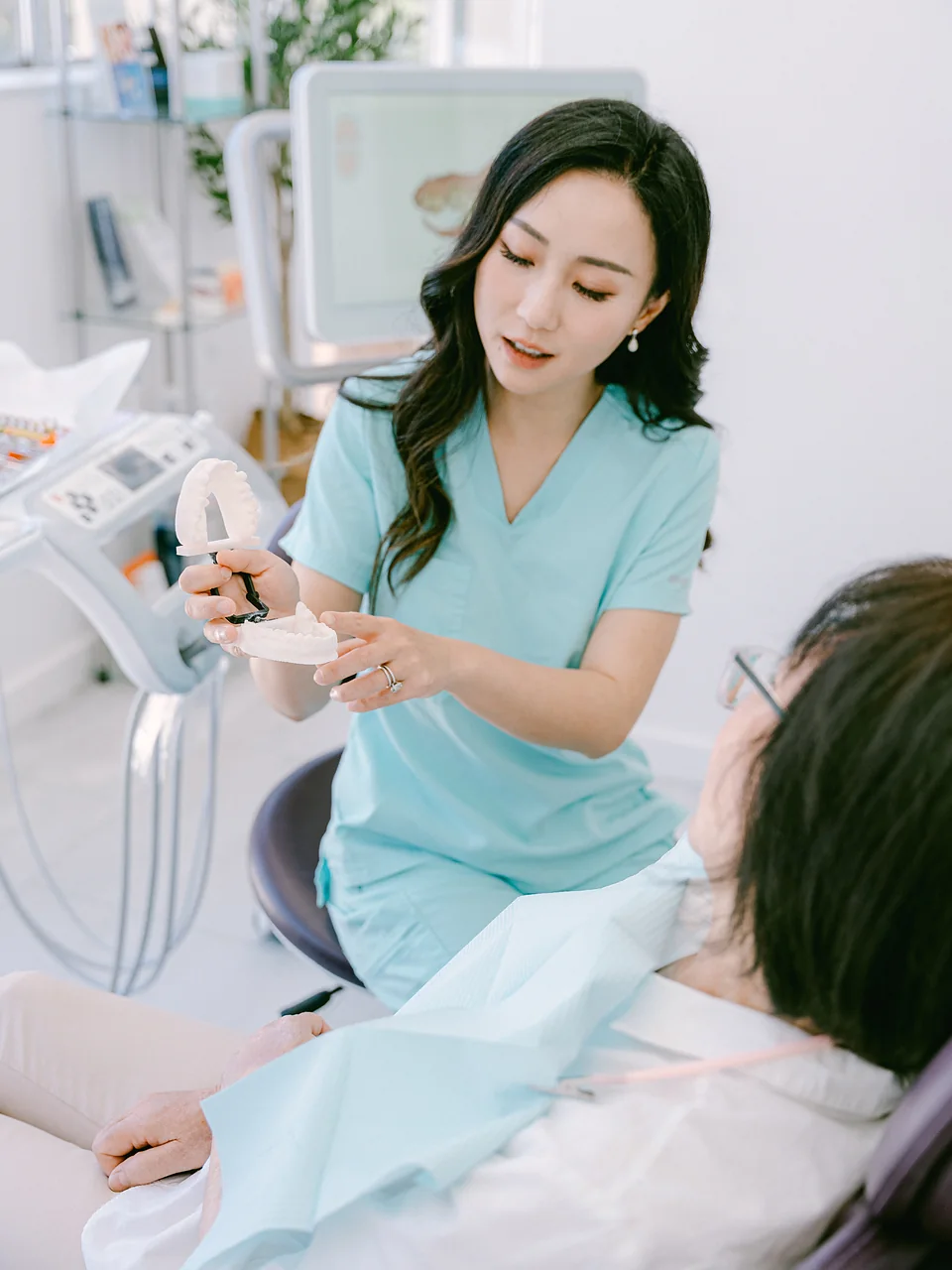 Doctor showing denture to patient